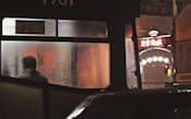 「思案橋」の停留場に路面電車が止まる。窓を染める光が乗客を夜の街へ誘う=写真　善家浩二