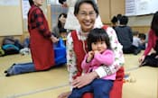 親がめのボランティアとしてデビューし、さっそく子どもを抱いた仲村邦子さん(横浜市神奈川区)