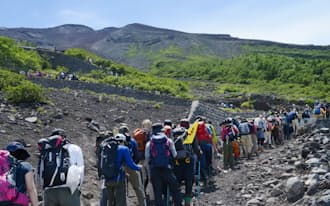 「山の日」ができ、山に親しむ機会が増えそう。列をつくって富士山の山頂を目指す人たち(2013年7月、山梨県の吉田ルート6合目)