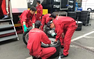 レースで使う交換用タイヤを拭く社員メカニックたち
