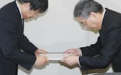 資源エネルギー庁の高原長官(左)に電気料金値上げを申請する東電の西沢社長（11日、経産省）