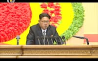 8日、北朝鮮の朝鮮中央テレビが放映した朝鮮労働党大会で報告する金正恩第1書記の映像=共同
