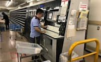 昨年末の郵便局では、職員が年賀はがきの集配作業に追われていた（17年12月26日、東京都新宿区の新宿郵便局）