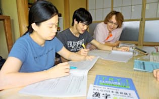 保護施設を運営する岡部文吾さん(右)と日本語を学ぶベトナム人技能実習生ら（6月26日、福島県郡山市）