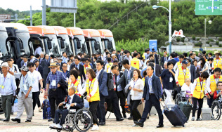 南北離散家族の再会事業に参加するため北朝鮮の金剛山に向かう韓国側参加者ら(20日、韓国の南北出入事務所)=AP 南北離散家族の再会事業に参加するため北朝鮮の金剛山に向かう韓国側参加者ら(20日、韓国の南北出入事務所)=AP
