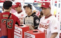 北海道で地震が発生してから初めての試合を前に8日、募金活動をする日本ハムの栗山監督（中央）と楽天の平石監督代行（右）=共同