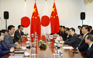 12日、ロシアのウラジオストクで会談する中国の習近平国家主席(右手前から2人目)と安倍首相(左手前から2人目)=共同 12日、ロシアのウラジオストクで会談する中国の習近平国家主席(右手前から2人目)と安倍首相(左手前から2人目)=共同