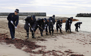 行方不明者の手掛かりを求め、福島県いわき市の砂浜を捜索するいわき東署員ら(8日午前)=共同 行方不明者の手掛かりを求め、福島県いわき市の砂浜を捜索するいわき東署員ら(8日午前)=共同