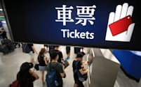 個人情報の追跡を防ぐため、デモ参加後の電車切符を現金で買う人たち（16日、香港）=三村幸作撮影
