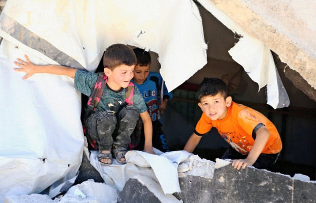 Syrian refugee kids play on rubble of dismantled concrete huts at a makeshift Syrian refugee camp in the Lebanese border town of Arsal, Lebanon July 4, 2019. Picture taken July 4, 2019. REUTERS/Mohamed Azakir Syrian refugee kids play on rubble of dismantled concrete huts at a makeshift Syrian refugee camp in the Lebanese border town of Arsal, Lebanon July 4, 2019. Picture taken July 4, 2019. REUTERS/Mohamed Azakir