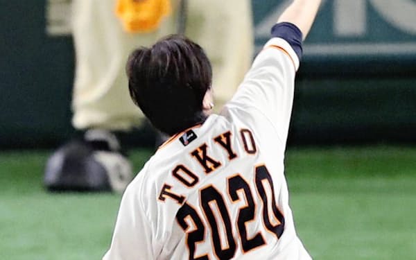 背番号「2020」のユニホームを着用して始球式を務める東京都の小池百合子知事（11日、東京ドーム）=共同