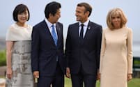 フランスのマクロン大統領（右から2人目）夫妻に迎えられる安倍首相夫妻（24日）=ロイター