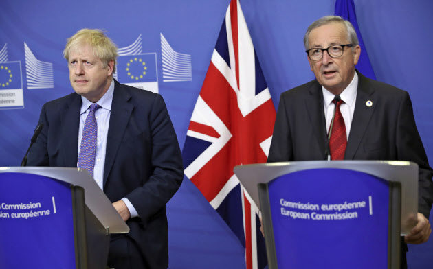 British Prime Minister Boris Johnson and European Commission President Jean-Claude Juncker make prepared statements during a press point at EU headquarters in Brussels, Thursday, Oct. 17, 2019. Britain and the European Union reached a new tentative Brexit deal on Thursday, hoping to finally escape the acrimony, divisions and frustration of their three-year divorce battle. (AP Photo/Francisco Seco) British Prime Minister Boris Johnson and European Commission President Jean-Claude Juncker make prepared statements during a press point at EU headquarters in Brussels, Thursday, Oct. 17, 2019. Britain and the European Union reached a new tentative Brexit deal on Thursday, hoping to finally escape the acrimony, divisions and frustration of their three-year divorce battle. (AP Photo/Francisco Seco)