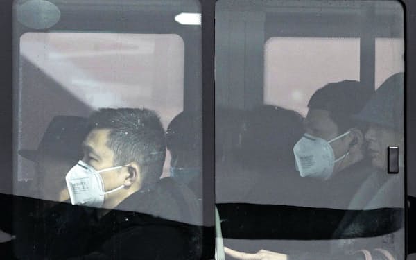 　バスの中でマスクを着用する市民ら。中国では新型コロナウイルスの感染の拡大が続いている（22日、北京）=共同