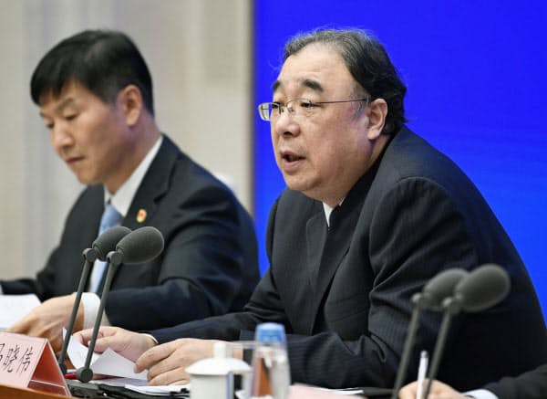 記者会見する中国国家衛生健康委員会の馬暁偉主任(右)(26日、北京)=共同