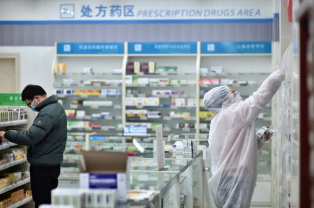 中国では新型コロナウイルスの新たな感染者数が減っている(6日、湖北省武漢市の薬局)=AP 中国では新型コロナウイルスの新たな感染者数が減っている(6日、湖北省武漢市の薬局)=AP