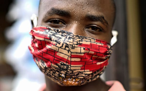 新型コロナウイルスへの感染防止に布製マスクを着用するルワンダ人男性=ロイター