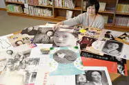 自ら手がけた向田邦子さんの企画展の歴代ポスターを紹介する、かごしま近代文学館の井上育子さん(2019年12月、鹿児島市)=共同 自ら手がけた向田邦子さんの企画展の歴代ポスターを紹介する、かごしま近代文学館の井上育子さん(2019年12月、鹿児島市)=共同