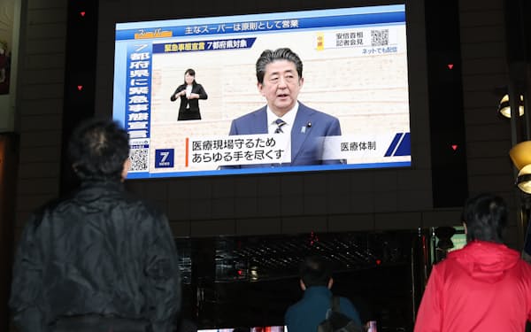 緊急事態宣言についての安倍首相の会見を放映する街頭ビジョン（7日、東京都新宿区）