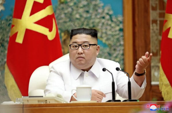 緊急招集された25日の会議に出席する金正恩氏=朝鮮中央通信・ロイター