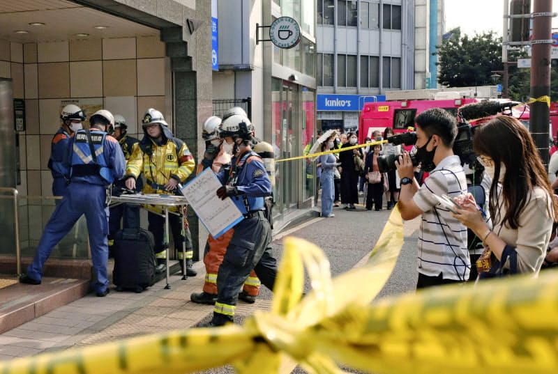 規制線が張られ、消防隊や通行人らで騒然とする福岡市地下鉄空港線の赤坂駅(23日午前、福岡市)=共同 規制線が張られ、消防隊や通行人らで騒然とする福岡市地下鉄空港線の赤坂駅(23日午前、福岡市)=共同
