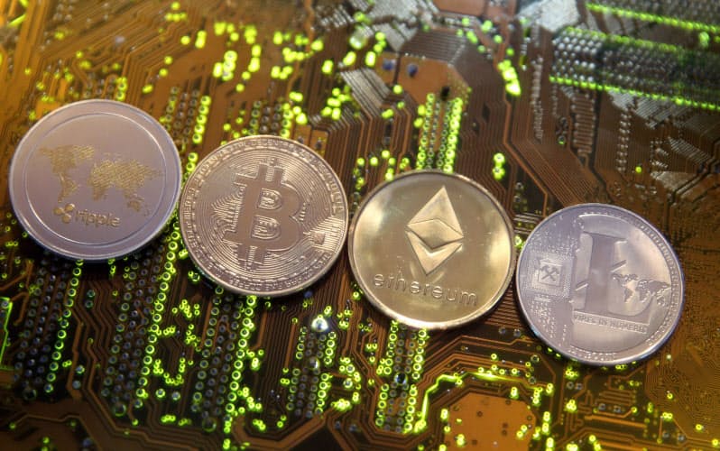 FILE PHOTO: Representations of the Ripple, Bitcoin, Etherum and Litecoin virtual currencies are seen on a PC motherboard in this illustration picture, February 13, 2018. REUTERS/Dado Ruvic/Illustration/File Photo FILE PHOTO: Representations of the Ripple, Bitcoin, Etherum and Litecoin virtual currencies are seen on a PC motherboard in this illustration picture, February 13, 2018. REUTERS/Dado Ruvic/Illustration/File Photo