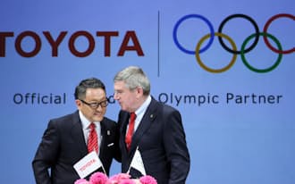 IOCのスポンサーに決まり、笑顔を見せるトヨタ自動車の豊田章男社長(左)と国際オリンピック委員会（IOC）のバッハ会長（13日午後、東京都千代田区）