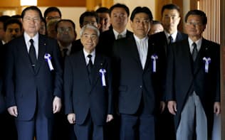 A group of lawmakers, including Japan's ruling Liberal Democratic Party (LDP) lawmaker Hidehisa Otsuji (2nd L) and former defense minister Seishiro Eto (L), walks as they offer prayers at Yasukuni Shrine in Tokyo August 15, 2015, to mark the 70th anniversary of Japan's surrender in World War Two. Japanese Prime Minister Shinzo Abe sent an offering to a shrine for war dead on Saturday, the 70th anniversary of Japan's World War Two defeat, but did not visit the shrine, seen in China and South Korea as a symbol of Tokyo's wartime militarism. REUTERS/Issei Kato