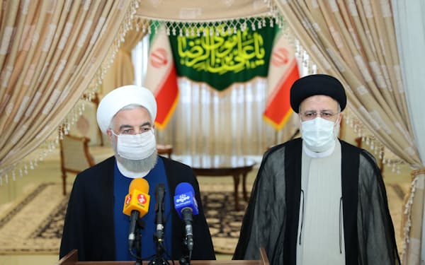 イラン大統領に就任するライシ師（右）は、政権に対する国民の信頼失墜の責任をロウハニ大統領（左）に負わせる（６月、テヘランでの記者会見）＝ロイター