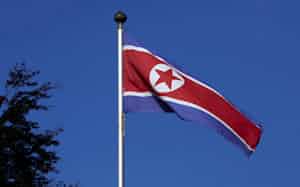 FILE PHOTO: A North Korean flag flies on a mast at the Permanent Mission of North Korea in Geneva October 2, 2014.   REUTERS/Denis Balibouse/File Photo