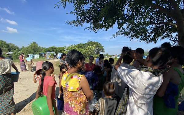 生活支援物資のコメを受け取るために集まる村人（ヤンゴン近郊）