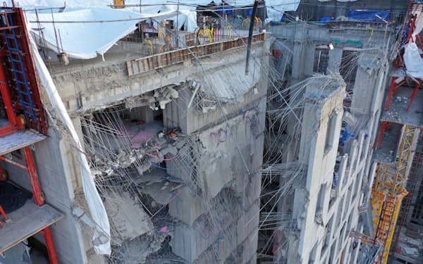The collapsed exterior wall of an apartment under construction is seen at a site in Gwangju, South Korea, Wednesday, Jan. 12, 2022. South Korean rescuers on Wednesday resumed their search for six missing construction workers believed to be trapped at a collapsed construction site in the southern city of Gwangju.  (Jung Hee-sung/Yonhap via AP)