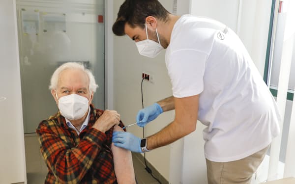 FILE - Kurt Switil, left, receives a Pfizer vaccination against the coronavirus in Vienna, April 10, 2021. Austria's parliament is due to vote Thursday, Jan. 20, 2022, on plans to introduce a COVID-19 vaccine mandate for the adult population, the first of its kind in Europe. (AP Photo/Lisa Leutner, File)