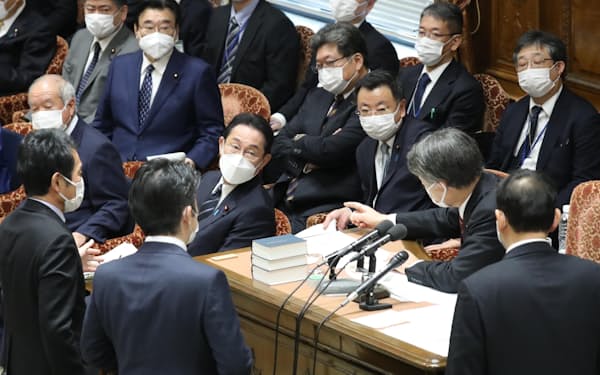 岸田首相の答弁を巡る議事運営について、委員長席に集まった野党の理事ら（25日）