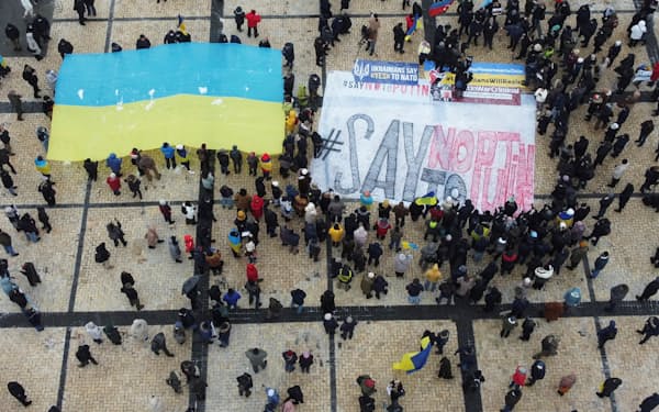 Demonstrators hold the Ukrainian national flag during a protest against Russian President Vladimir Putin's policies, in Kyiv, Ukraine January 9, 2022. Picture taken with a drone. REUTERS/Valentyn Ogirenko