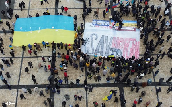 Demonstrators hold the Ukrainian national flag during a protest against Russian President Vladimir Putin's policies, in Kyiv, Ukraine January 9, 2022. Picture taken with a drone. REUTERS/Valentyn Ogirenko