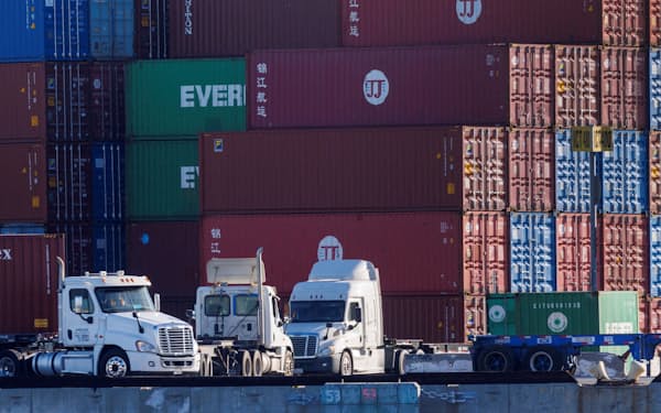 FILE PHOTO: Trucks arrive to pick up containers at the Port of Los Angeles in Los Angeles, California, U.S. November 22, 2021. REUTERS/Mike Blake/File Photo