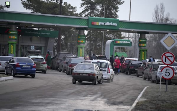 People queue for fuel at a gas station in Sievierodonetsk, the Luhansk region, eastern Ukraine, Thursday, Feb. 24, 2022. Russian President Vladimir Putin on Thursday announced a military operation in Ukraine and warned other countries that any attempt to interfere with the Russian action would lead to "consequences you have never seen." (AP Photo/Vadim Ghirda)