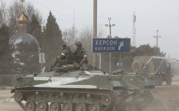 Servicemen ride on a Russian Army military armoured vehicle with the letter 'Z' on it, after Russian President Vladimir Putin authorized a military operation in eastern Ukraine, in the town of Armyansk, Crimea, February 24, 2022. REUTERS/Stringer