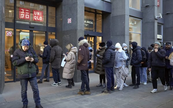 People line up at a Uniqlo store after the announcement that Uniqlo stores are suspending trade in Russia from March 21, in St. Petersburg, Russia, Thursday, March 10, 2022. (AP Photo)