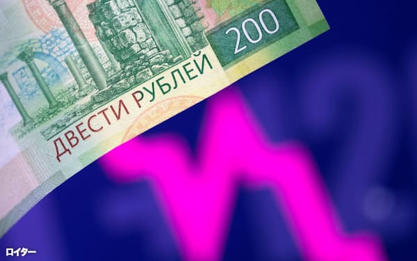 FILE PHOTO: A Russian rouble banknote is seen in front of a descending stock graph in this illustration taken March 1, 2022. REUTERS/Dado Ruvic/Illustration/File Photo