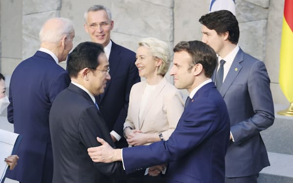 　G7首脳会合を前に、フランスのマクロン大統領（手前右）と言葉を交わす岸田首相＝24日、ブリュッセル（内閣広報室提供・共同）