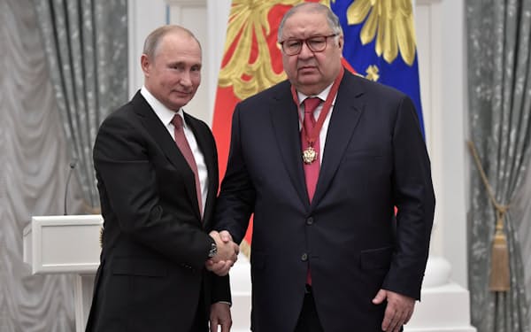 プーチン氏（左）から表彰されるウスマノフ氏（18年11月、モスクワ）=ロイター