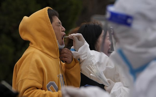 FILE - Residents get their throat swab at a coronavirus testing site near residential buildings, Wednesday, April 6, 2022, in Beijing. An extra-contagious version of the omicron coronavirus variant has taken over the world. The variant scientists call BA.2 is now dominant in at least 68 countries, including the U.S. The World Health Organization says it makes up about 94% of sequenced omicron cases submitted in the most recent week to an international database. (AP Photo/Andy Wong, File)