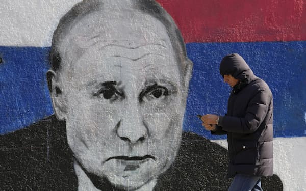 A man passes by a mural depicting the Russian President Vladimir Putin in Belgrade, Serbia, Saturday, March 12, 2022. While Serbia has criticized the attack on Ukraine and voted in the United Nations for the condemnation of the attack, Belgrade has refrained from joining Western sanctions against Moscow. Historically considered a friendly nation, Russia remains popular among the Serbs, particularly because of Moscow's support for Serbia's opposition to the Western-backed independence of the breakaway former Kosovo province. (AP Photo/Darko Vojinovic)