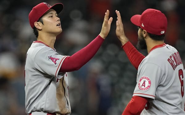 Los Angeles Angels' Shohei Ohtani, left, and Anthony Rendon (6) celebrate after a baseball game against the Houston AstrosWednesday, April 20, 2022, in Houston. The Angels won 6-0.(AP Photo/David J. Phillip)
