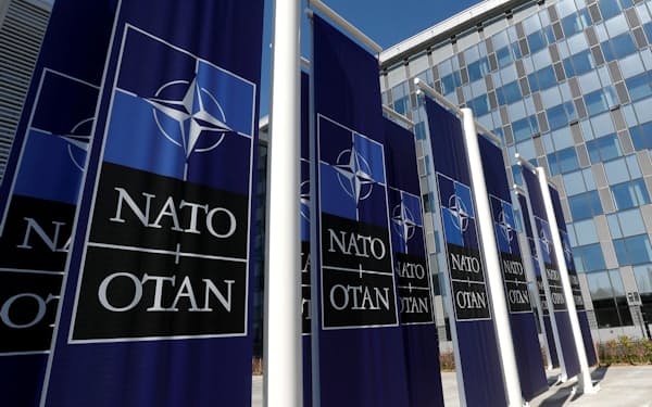 FILE PHOTO: Banners displaying the NATO logo are placed at the entrance of new NATO headquarters during the move to the new building, in Brussels, Belgium April 19, 2018.  REUTERS/Yves Herman/File Photo