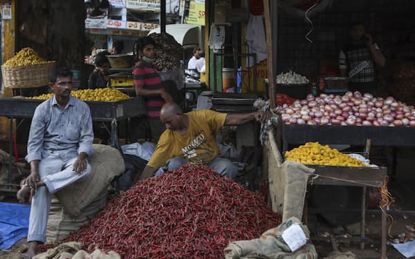 Indian vendors wait for customers while selling essential commodities at a wholesale market in Hyderabad, India, Wednesday, May 4, 2022. India's central bank on Wednesday raised its key interest rate to 4.4% from 4% to try to contain fast-rising inflation. (AP Photo/Mahesh Kumar A.)