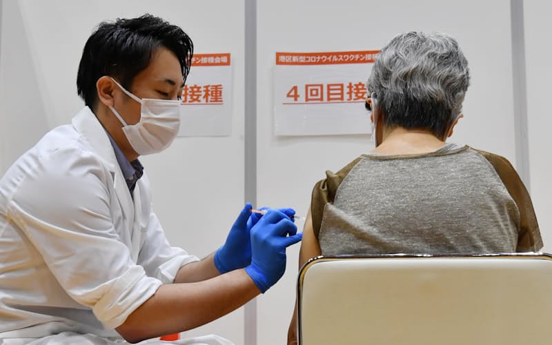 4回目のワクチン接種を受ける女性（25日午前、東京都港区）