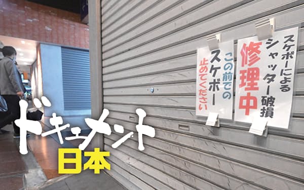 スケートボードのタイヤ痕が目立つ服飾雑貨店のシャッター。注意喚起を伝える張り紙が掲げられていた（神戸市中央区）